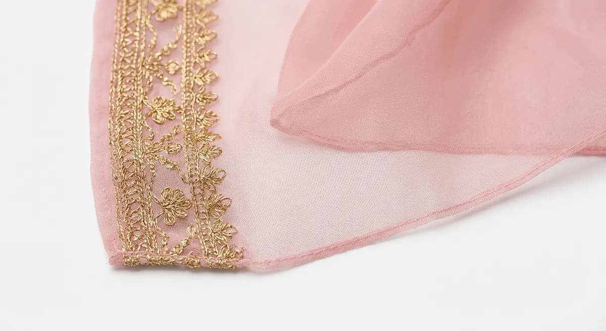 Sheer chiffon dupatta with transparent edges preserved during AI background removal showing accurate fabric boundary detection